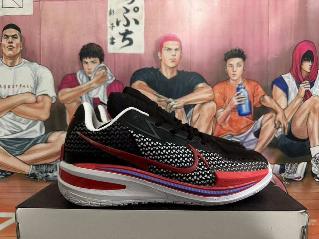 Side view of a black basketball shoe with patterned panels, red logo, and white midsole