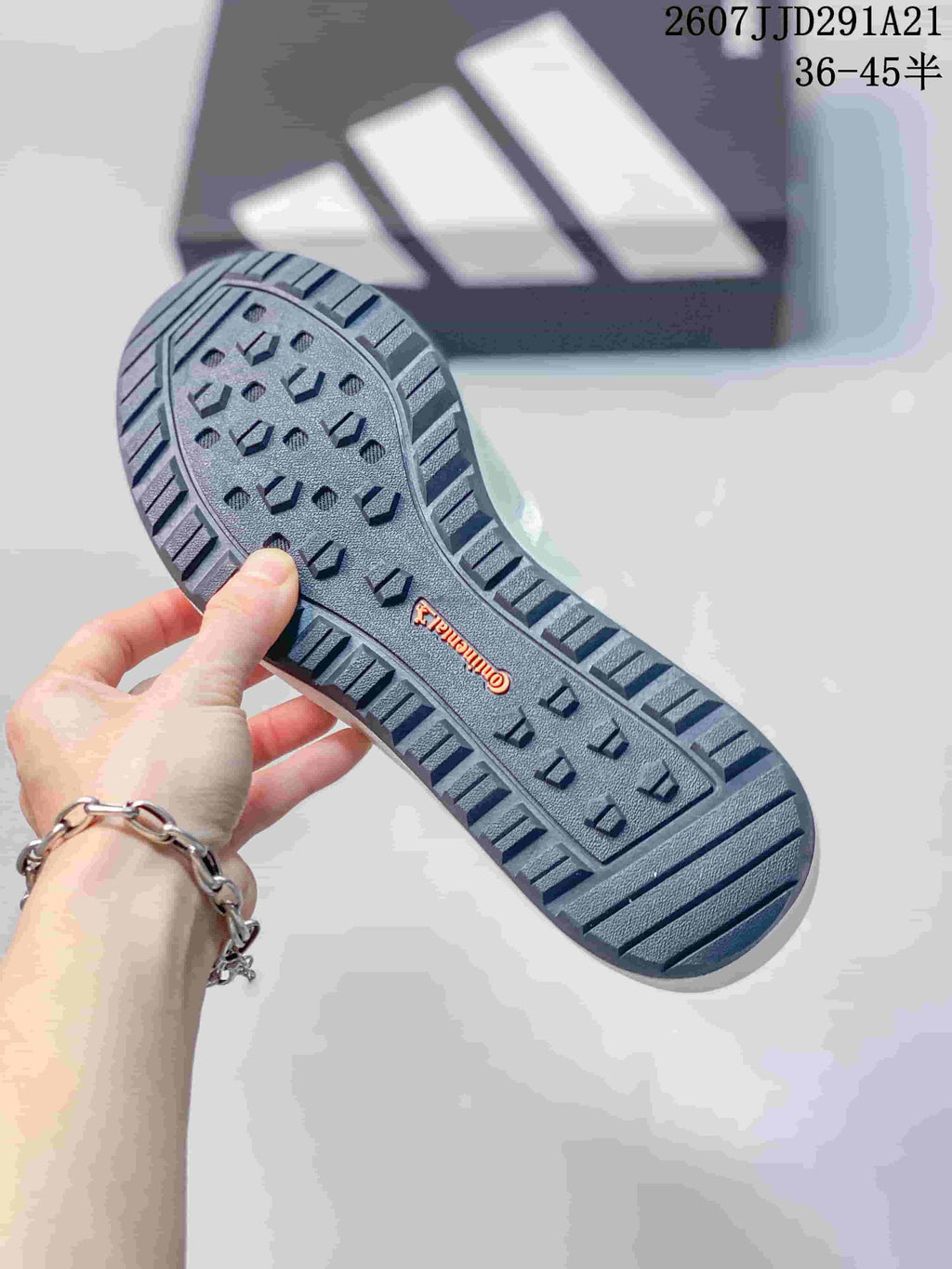 Close-up of the dark lugged outsole showing the tread pattern and Terrex marking.