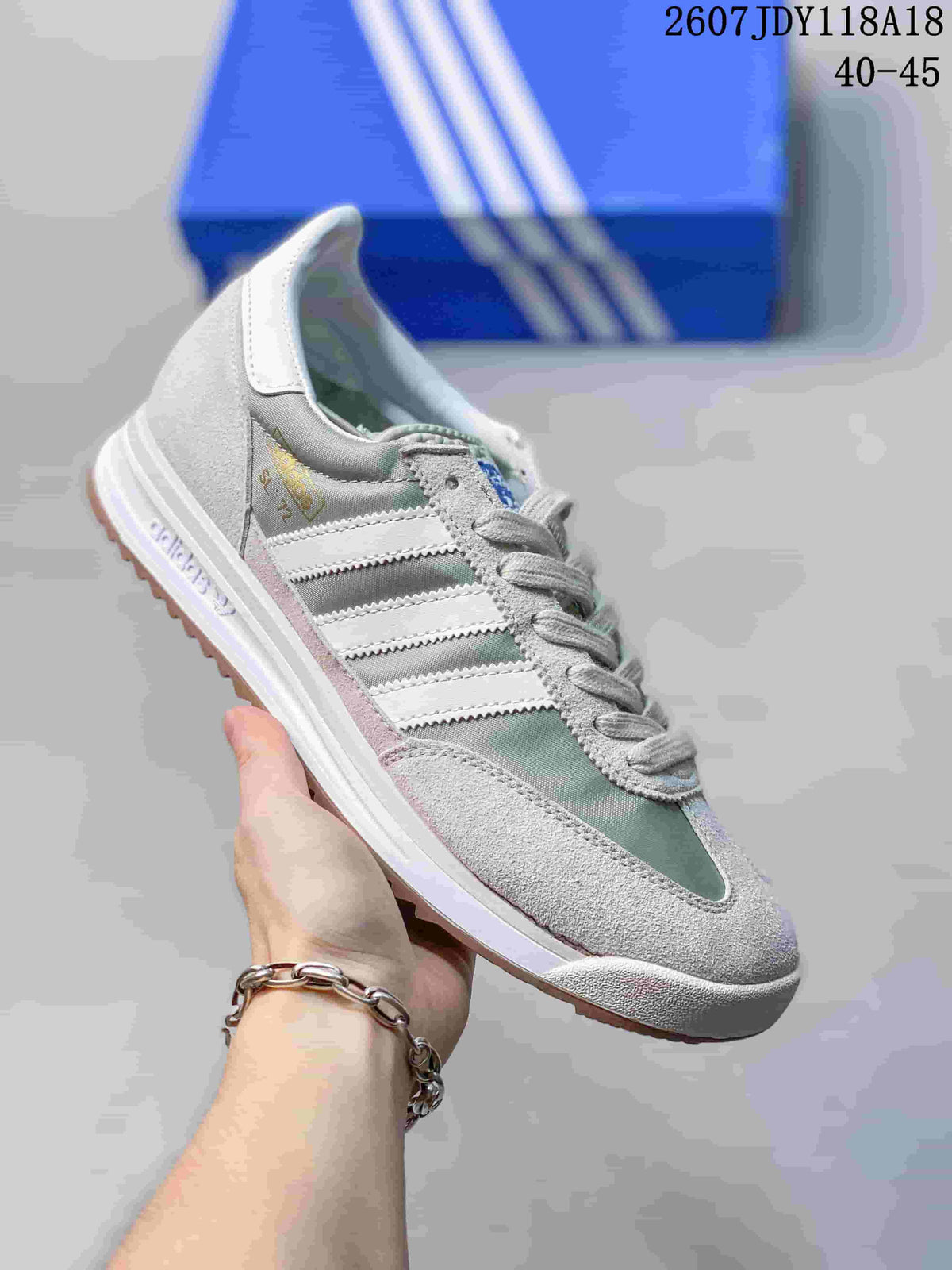 Light gray adidas SL 72 sneaker with white stripes and pale green paneling.