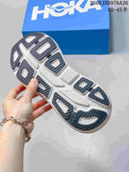 View of the patterned outsole on a gray HOKA Bondi 9 shoe