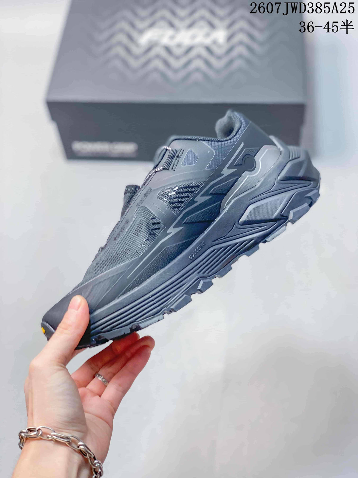 Side view of the dark gray Kailas shoe showing mesh panels, layered midsole and lugged tread.