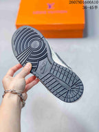 Close-up of the dark rubber outsole showing circular traction at the forefoot and patterned tread across the heel.