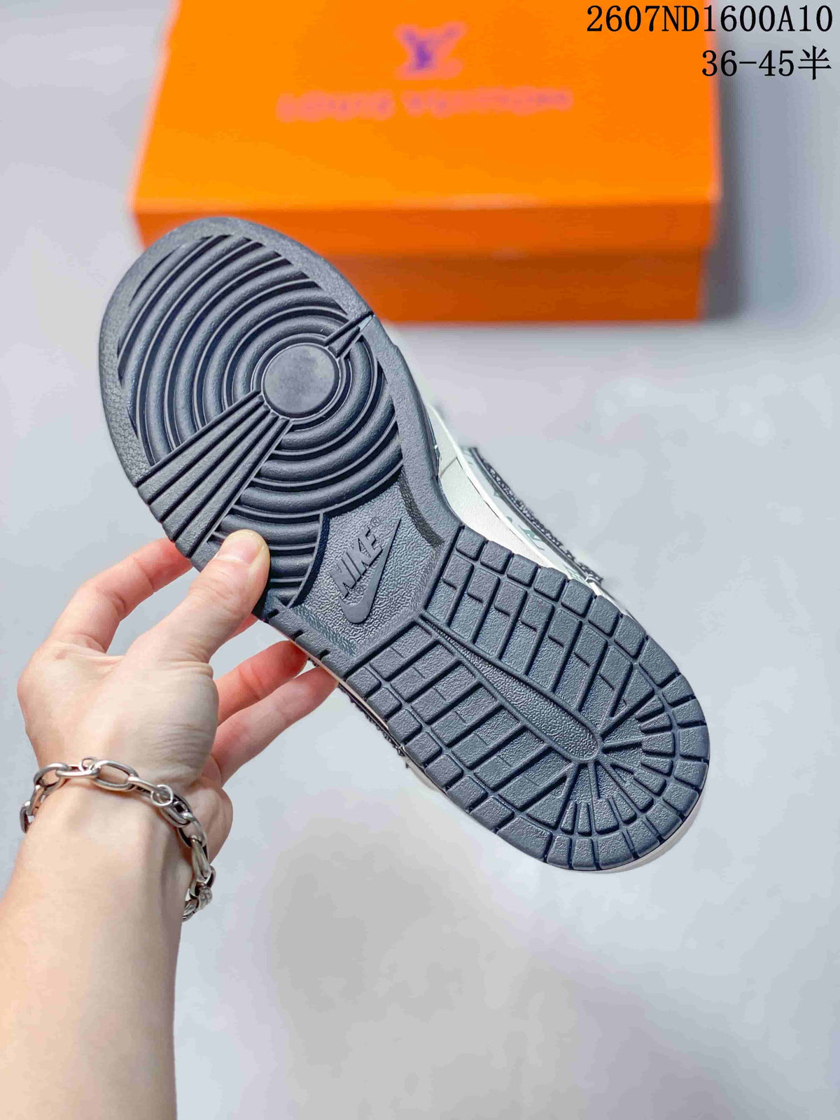 Close-up of the dark rubber outsole showing circular traction at the forefoot and patterned tread across the heel.