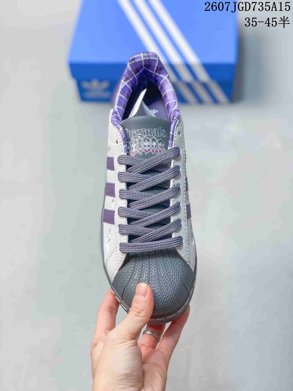 Top view of the lace-up sneaker showing the gray shell toe, purple lining and printed tongue design.