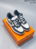 Pair of cream and charcoal Nike Air Force 1 Low-style custom sneakers on an orange box