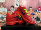 Pair of red basketball sneakers with black Swooshes and bright green laces