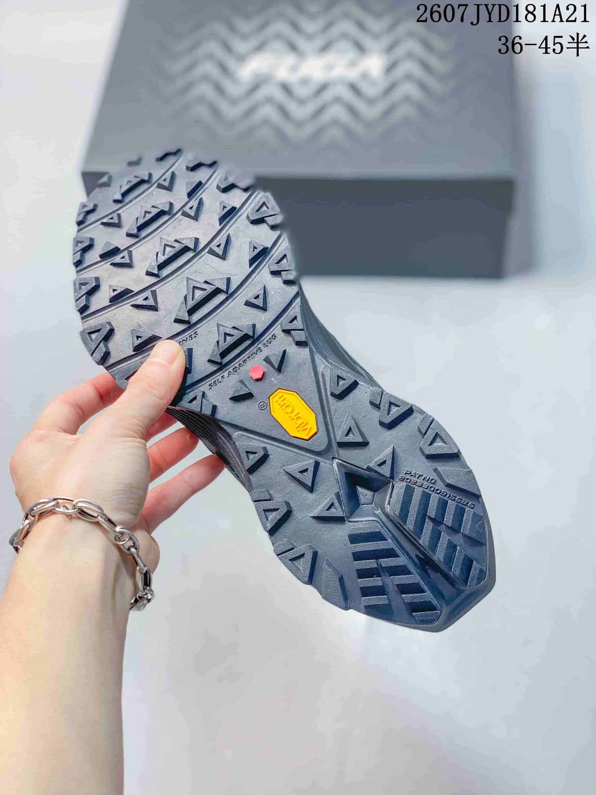 Close view of the lugged outsole showing triangular tread elements and visible Vibram branding.