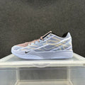 Side view of a blue, white, and pink Nike low-top basketball sneaker with patterned panels and a white sole.