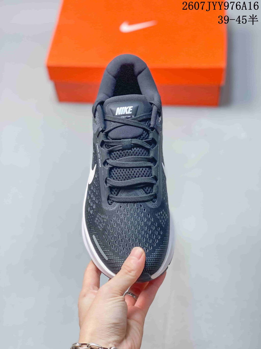 Top view showing the mesh-textile toe box, laces, padded tongue, and Nike Structure 23 tongue label.