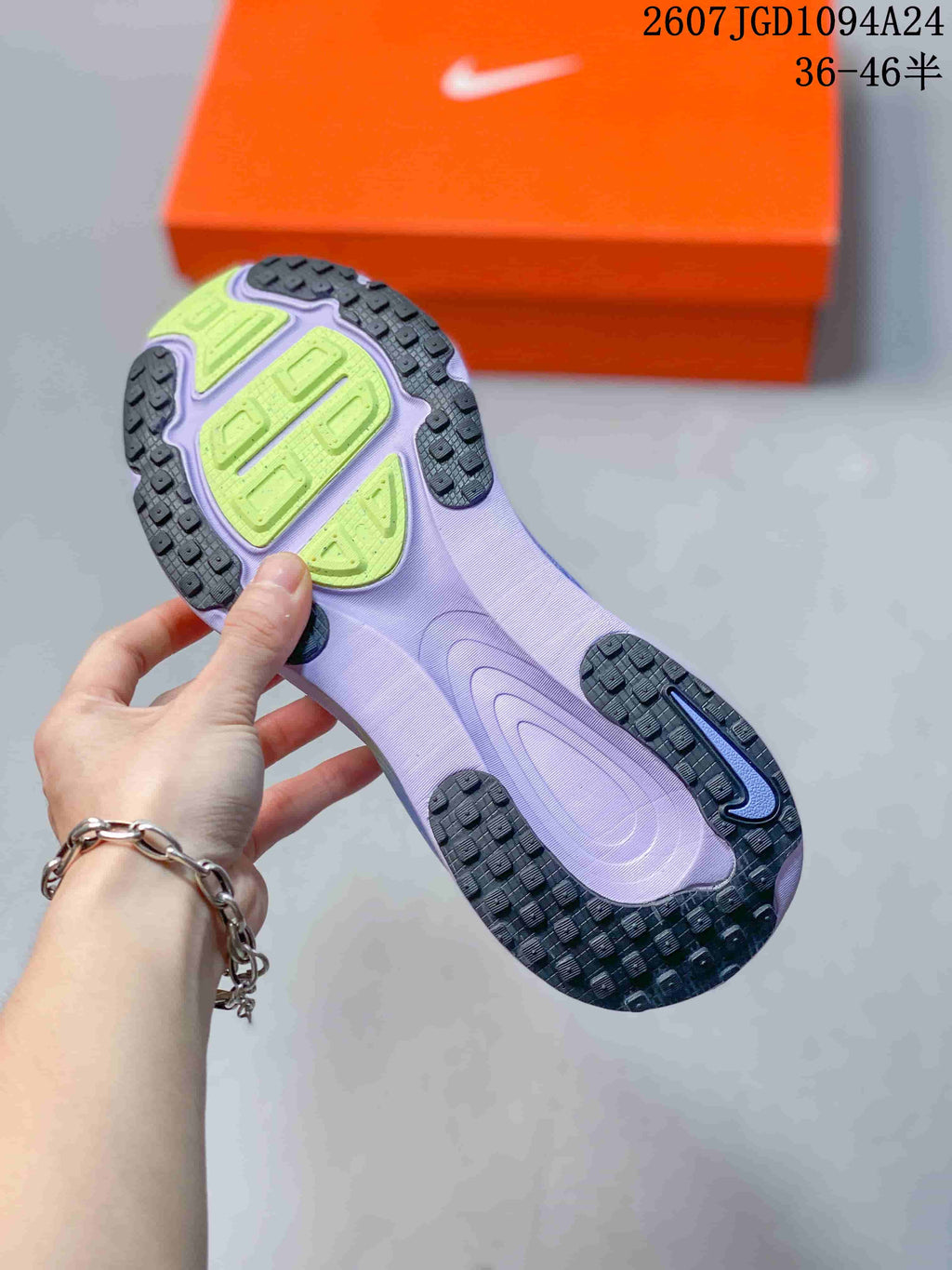 Close view of the sneaker outsole showing black textured rubber sections and lime-green traction areas.