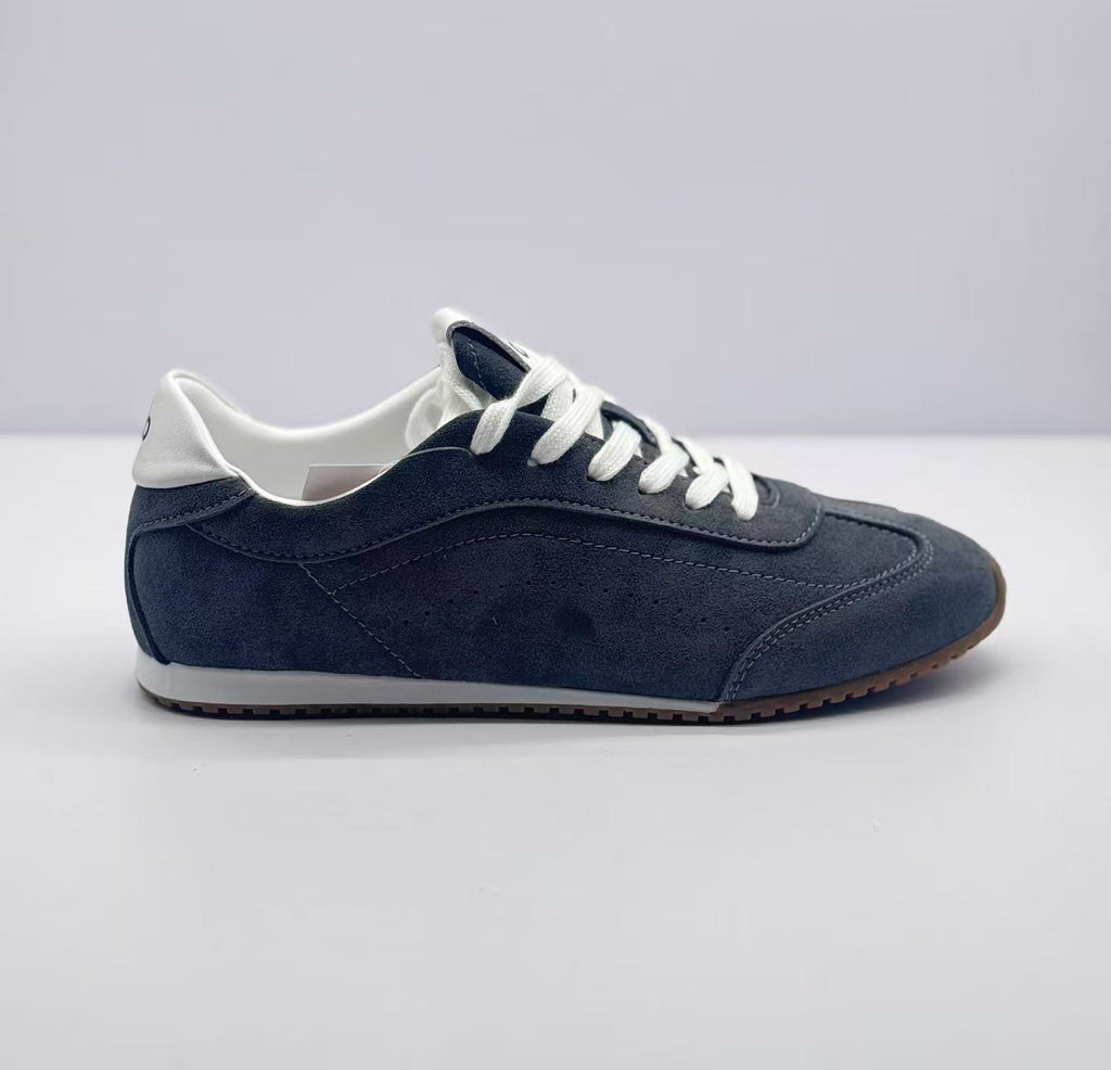 Side profile of carbon gray Alo low-top sneakers with white laces, white collar, and brown outsole.