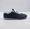 Side profile of carbon gray Alo low-top sneakers with white laces, white collar, and brown outsole.