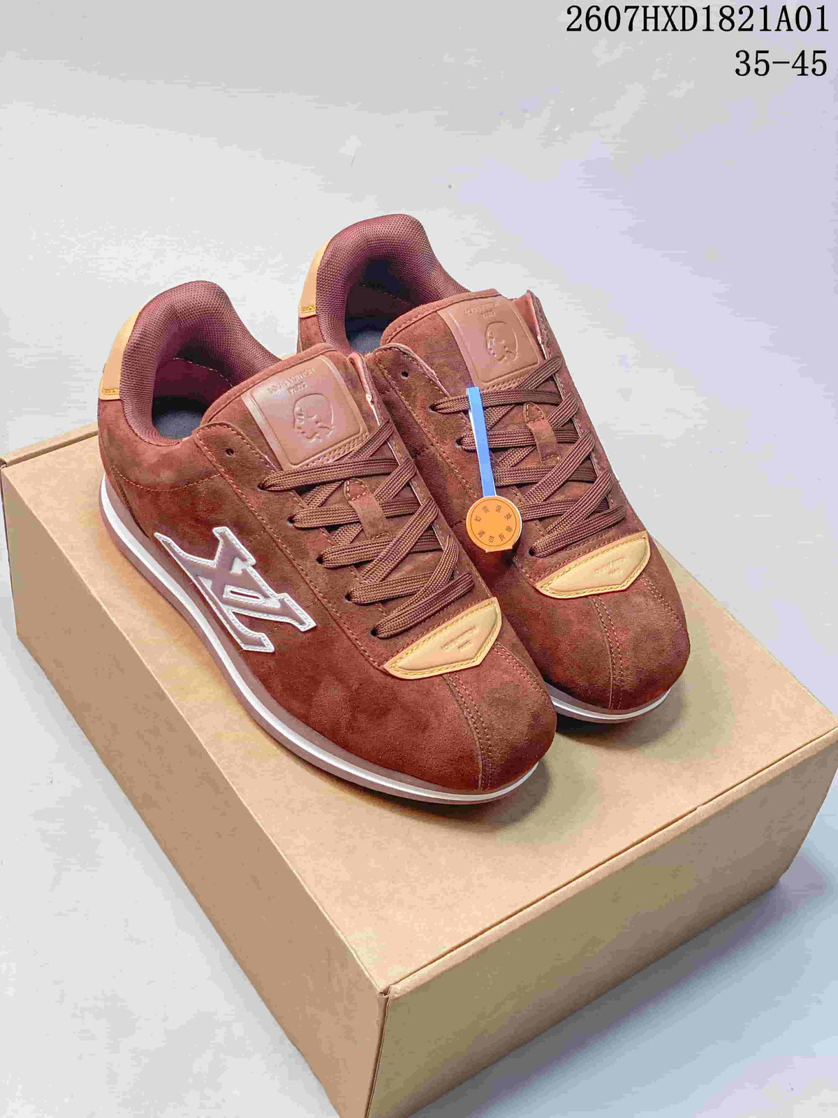 Pair of reddish-brown low-top sneakers with tonal laces and contrasting side emblems.