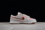 Side profile highlighting the pink and gray panels, layered Swoosh design, and low-top shape.