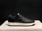 Side profile of the sneaker showing the BAPE-marked midsole and contrasting black and white color scheme.