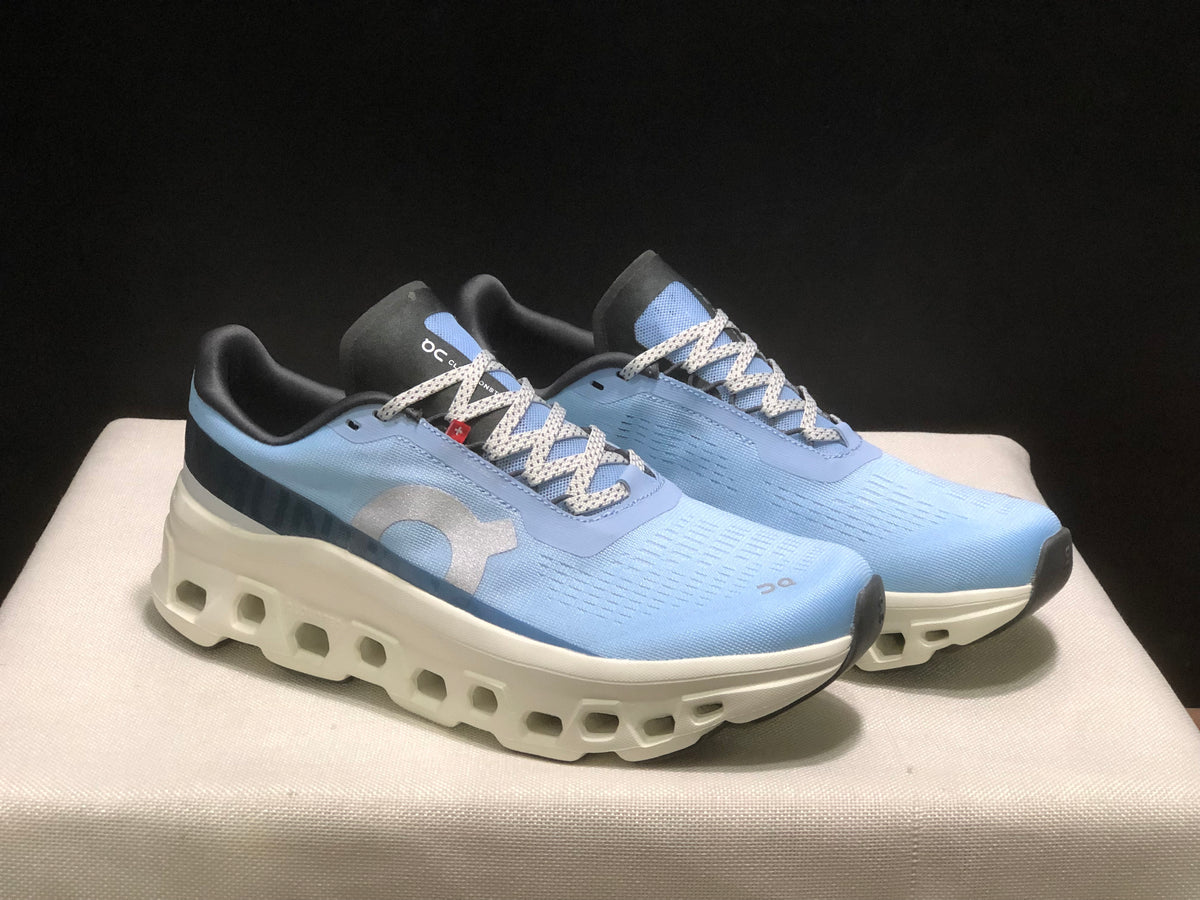 Three-quarter view of the pair highlighting the lace-up construction, side branding, and sculpted white soles.