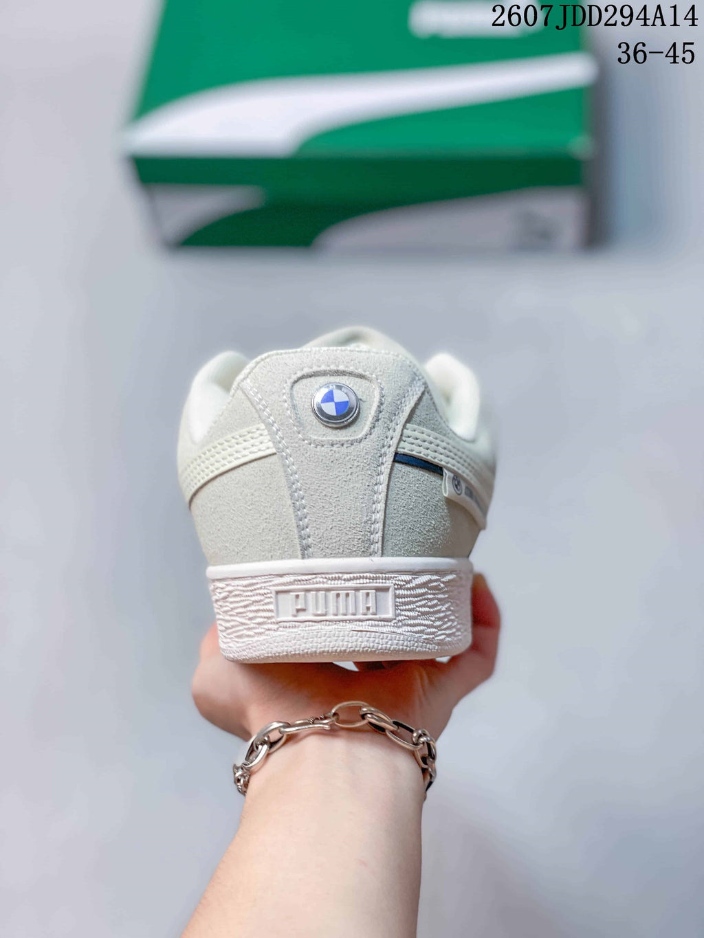 Rear view of the white sneaker showing the padded heel, PUMA branding and circular heel emblem.