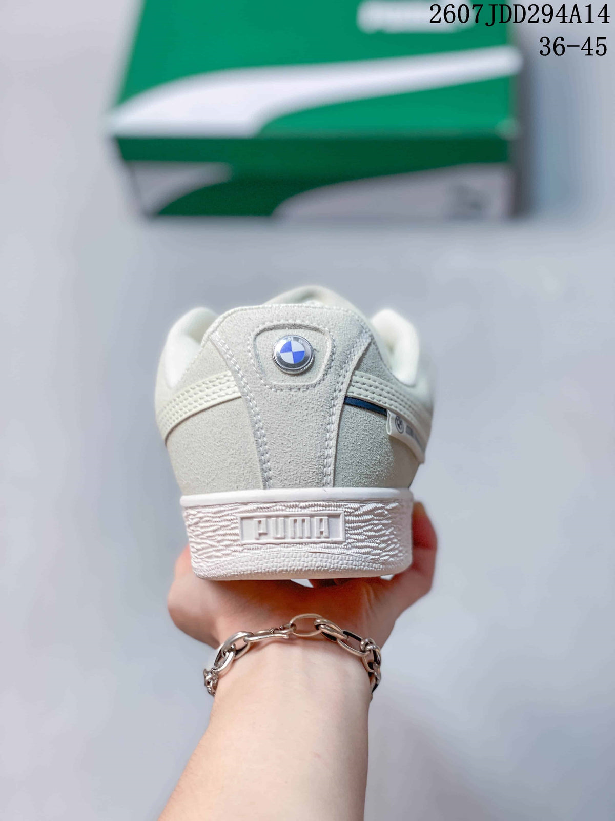 Rear view of the white sneaker showing the padded heel, PUMA branding and circular heel emblem.