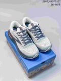 Pair of grey and navy Brooks Glycerin Max running shoes displayed on a blue shoe box.