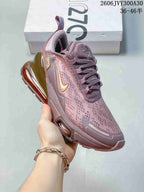 Close side view of the mauve sneaker with gold-tone accents