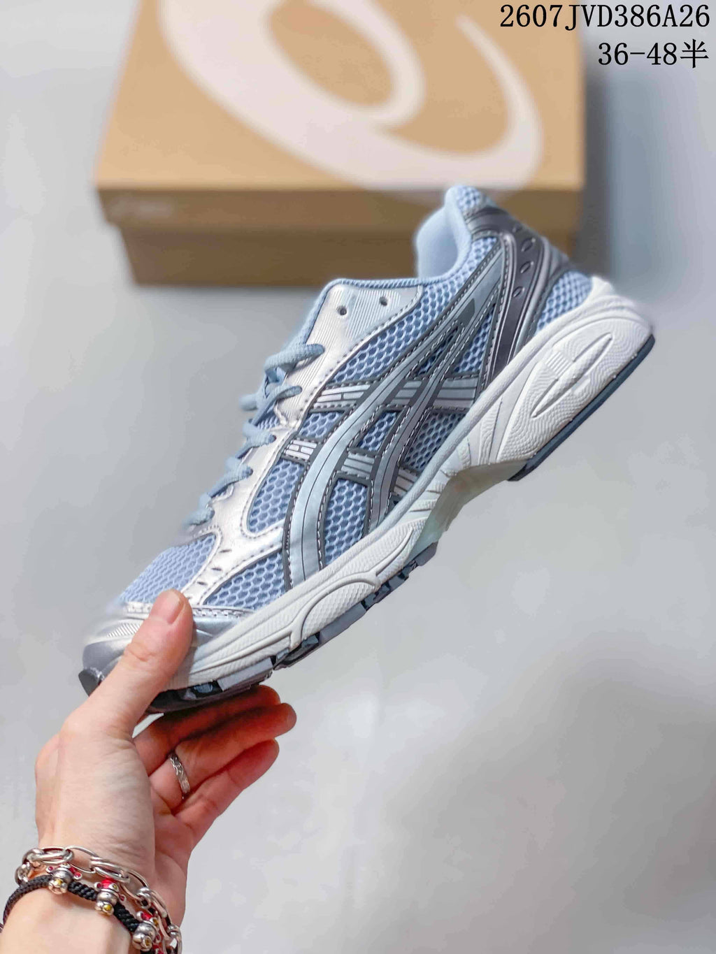 Side profile showing the mesh upper, silver overlays, ASICS branding, and cushioned midsole.