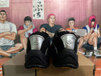 Rear view of black Nike sneakers with silver-tone heel panels.
