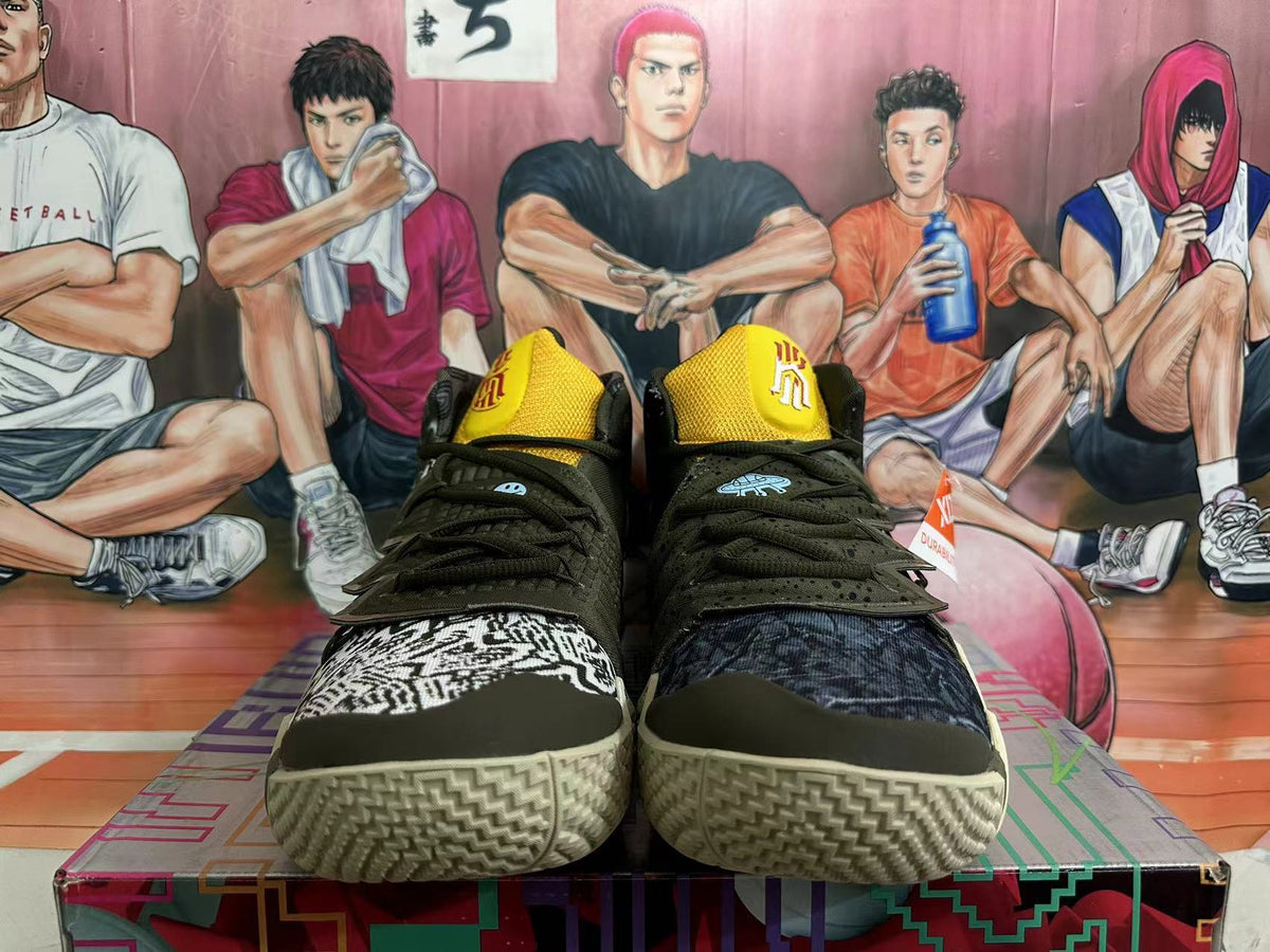 Front view showing yellow tongues, dark laces, contrasting patterned toe panels, and textured soles.