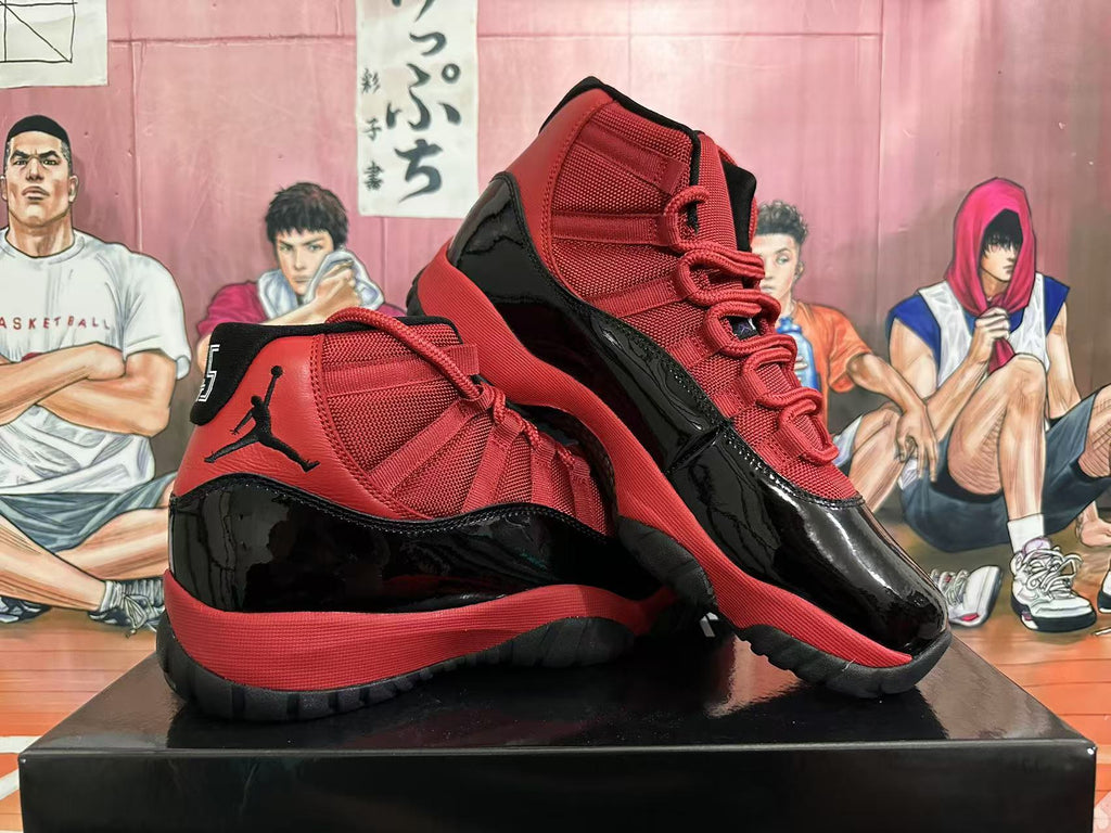 Pair of black and red high-top sneakers arranged together, showing their red uppers, glossy black overlays, and high-top construction.