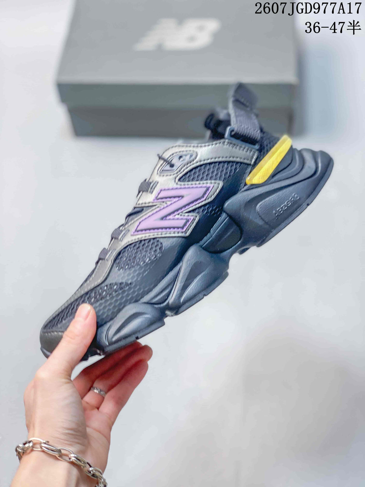 Side profile of the New Balance 9060 sneaker showing the layered purple logo, mesh panels, sculpted thick sole and yellow heel accent.