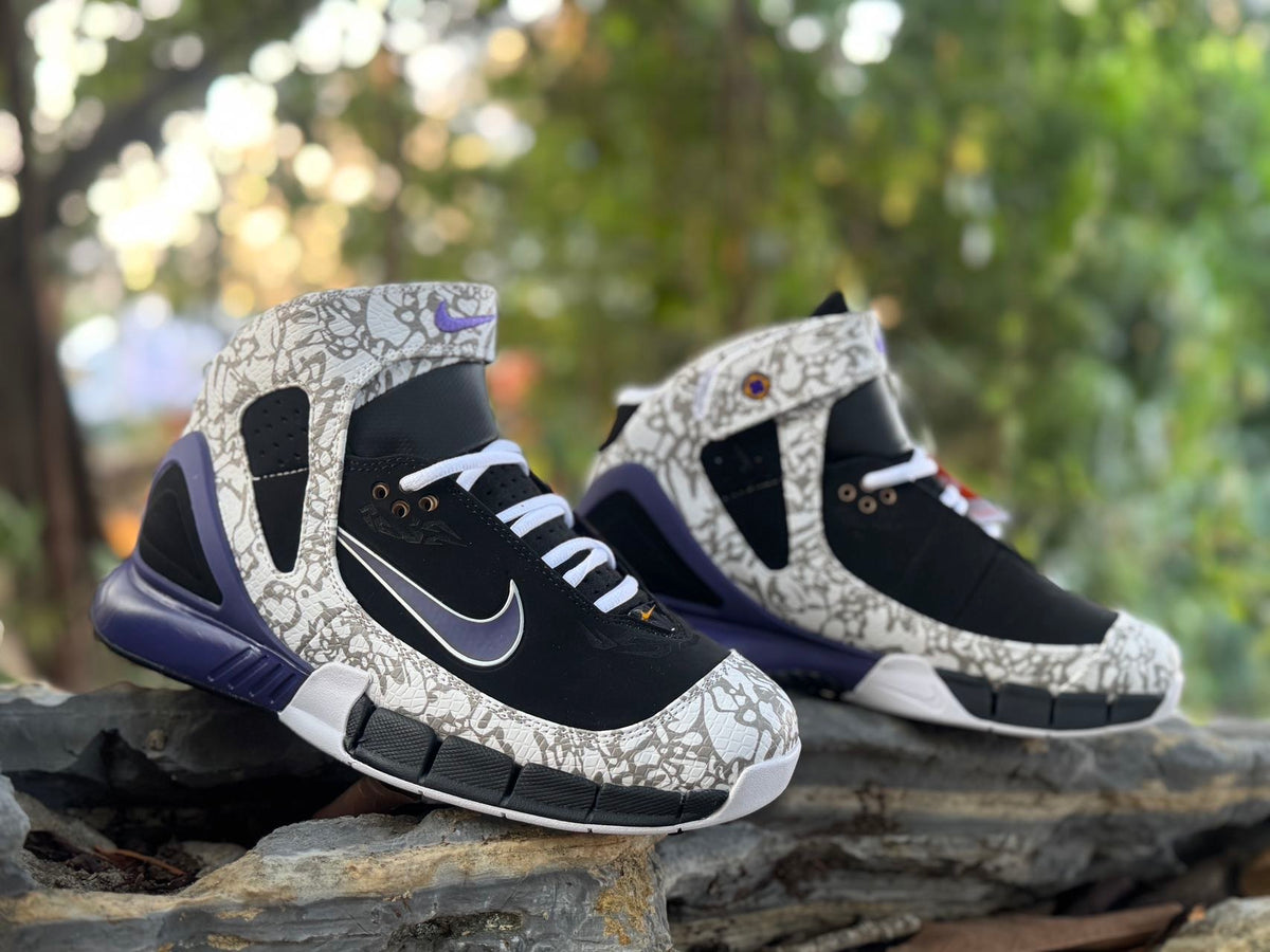 Pair of black and grey patterned high-top sneakers with purple-blue accents