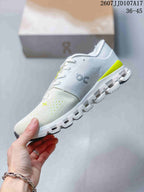 Side view of the white and lime sneaker showing the On logo, knit-style upper, lace-up closure, and segmented sole.