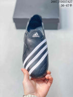 Top view showing the white adidas logo, broad white stripes, and perforated toe panel