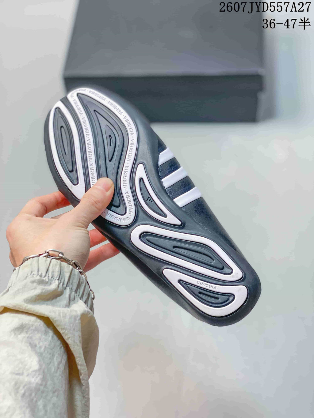 Close view of the patterned outsole with raised tread sections and printed text