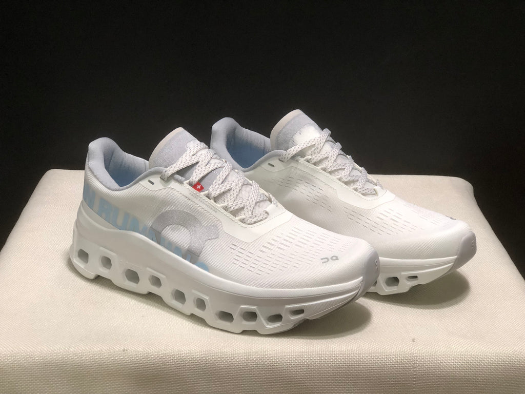 Three-quarter view of the ivory and glacier running shoes, highlighting the lace panels, side branding, and thick sculpted soles.