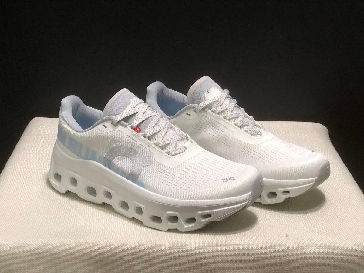 Three-quarter view of the ivory and glacier running shoes, highlighting the lace panels, side branding, and thick sculpted soles.