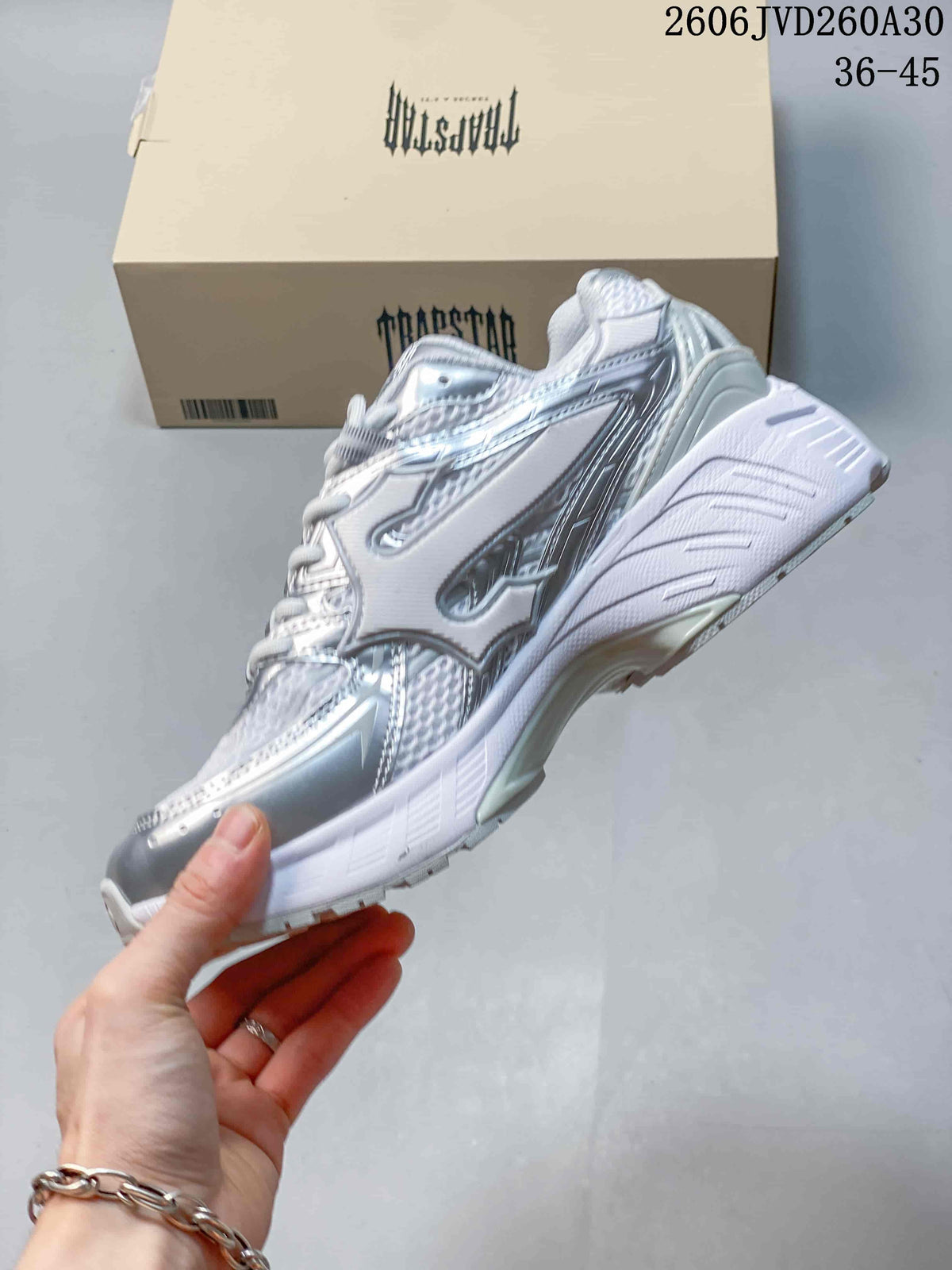 Side profile of the silver and white Trispeed 3000 Trainer