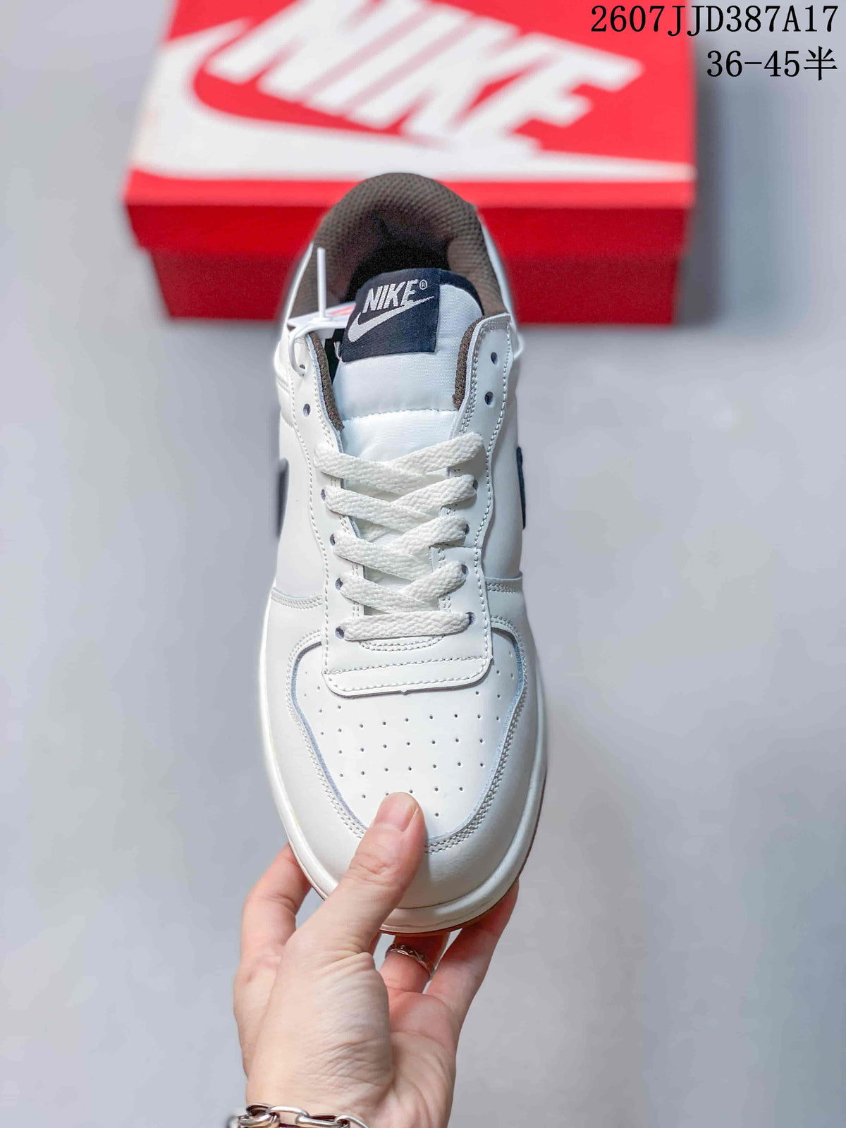 Top view showing the white laces, padded tongue, perforated toe box and navy tongue label.