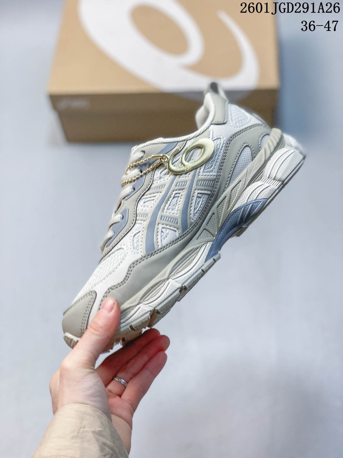 Side view of a white and grey sneaker with layered panels and mesh details