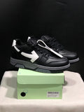 Pair of black low-top sneakers with white arrow side details displayed on a light green shoe box; the box label shows size 41.