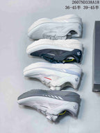 Multiple white and black Descente sneakers arranged side by side to show the available color variations and outsole profiles.