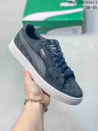 Dark gray PUMA Suede XL sneaker with matching side stripes, dark laces and a white outsole.