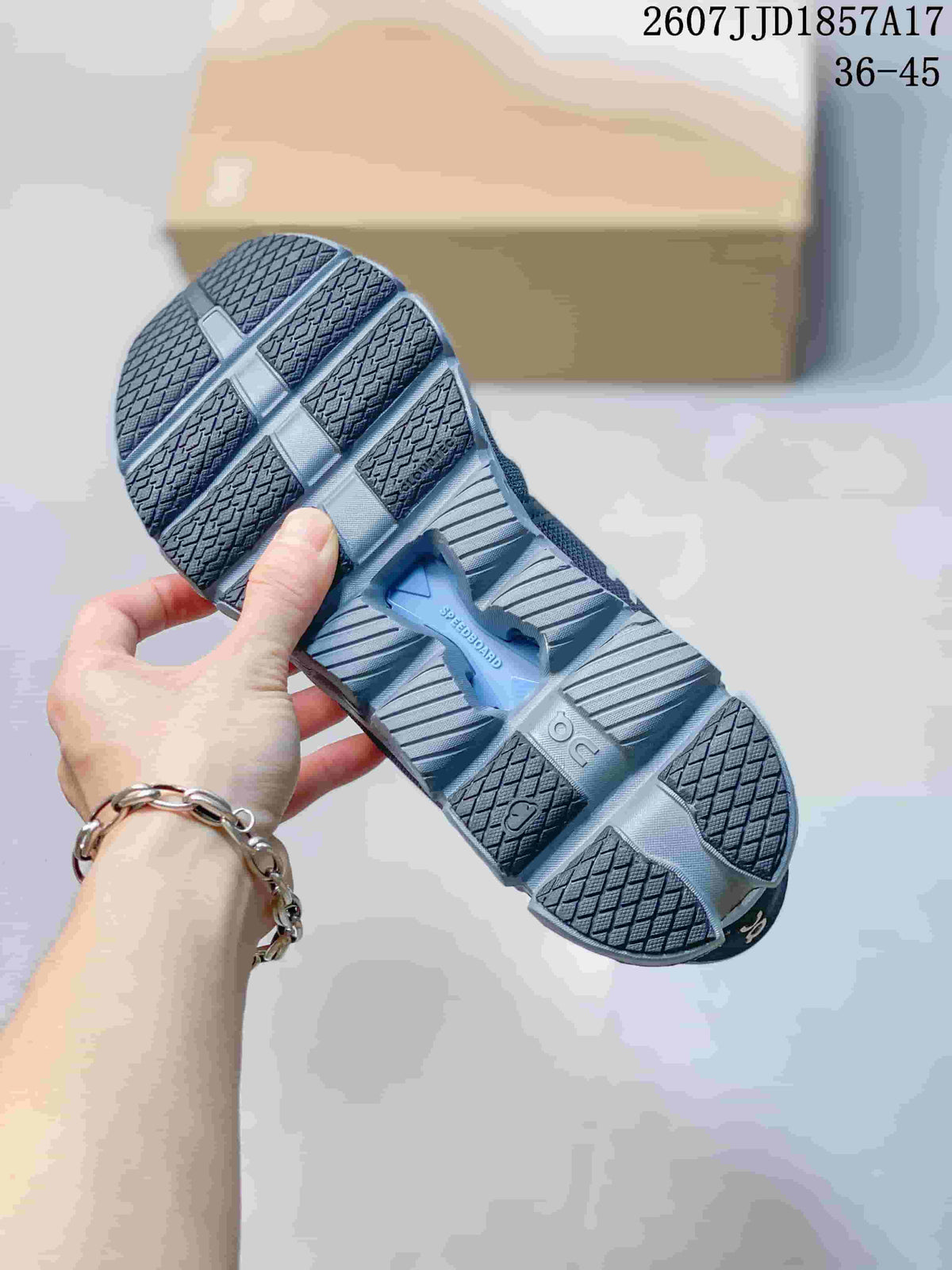 Outsole view of a dark gray sneaker showing the segmented tread pattern and cushioned sole structure.