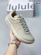 Angled side view of a light neutral lululemon Cityverse sneaker showing the lace-up upper, padded collar and textured outsole.