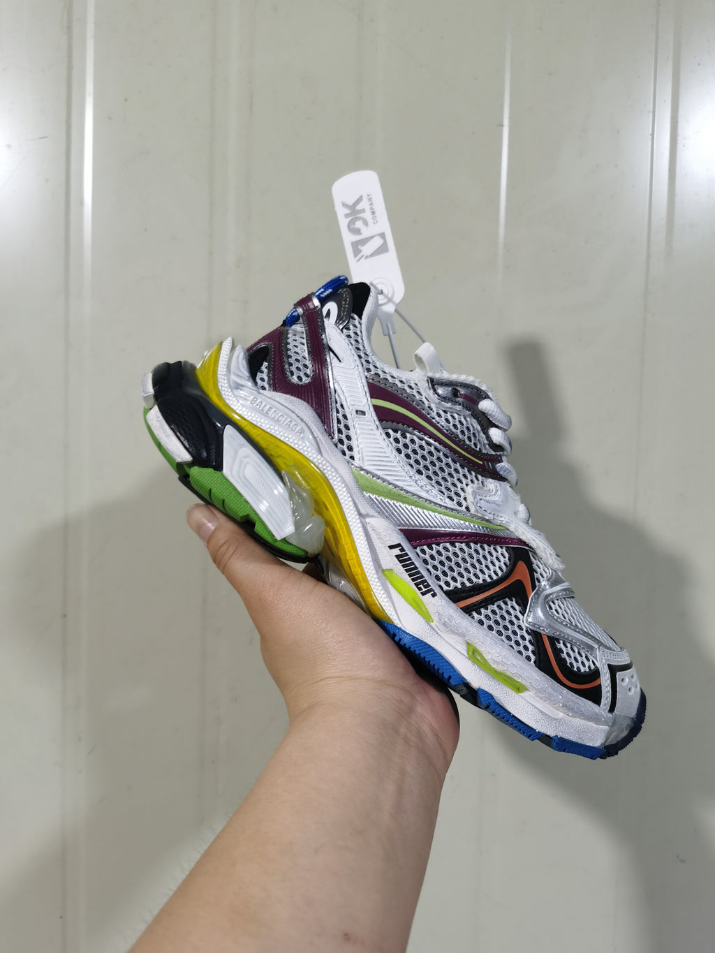 Close-up view of a multicolor Balenciaga Runner sneaker showing its layered upper, mesh-style panels and sculpted sole.