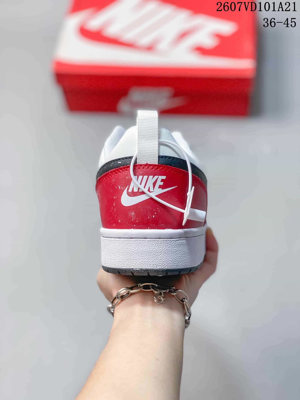Rear view showing the red heel panel, white Nike branding and padded collar.