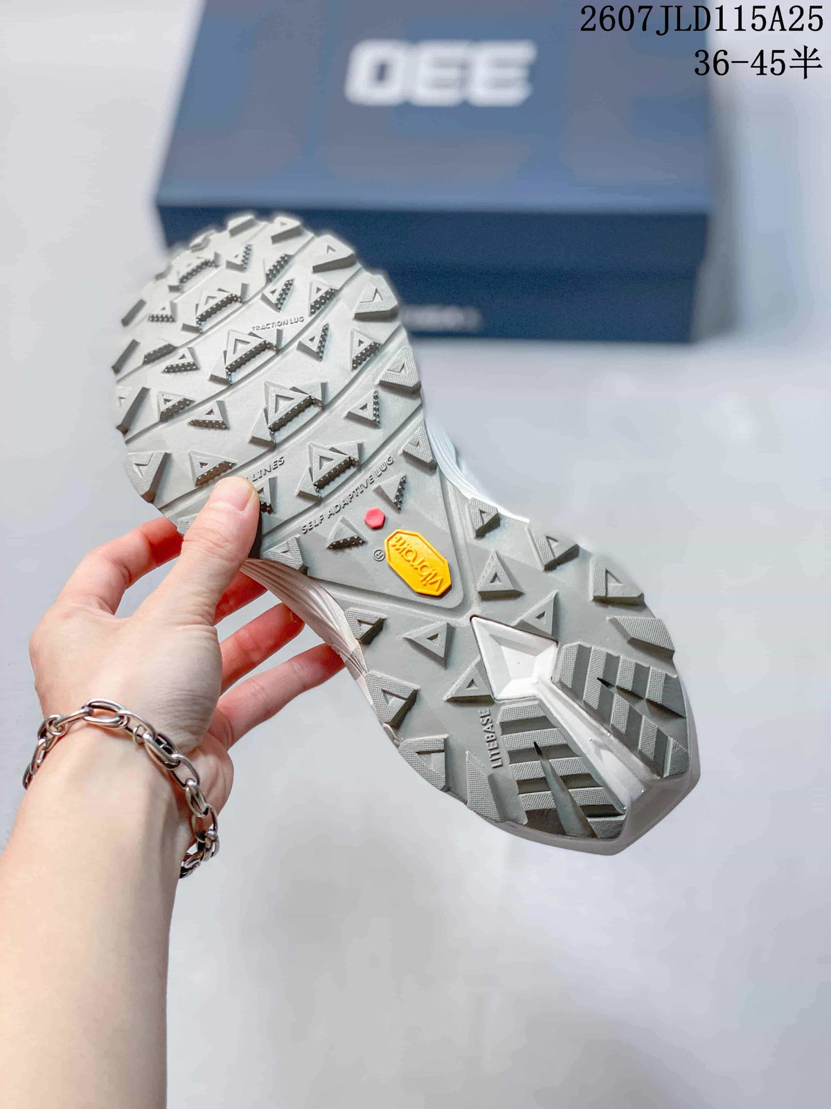 Close-up of the lugged outsole showing triangular traction elements and visible Vibram branding.