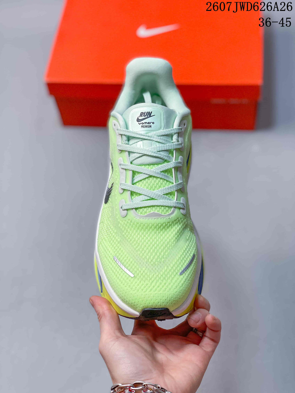 Front view of the green lace-up sneaker showing the textured toe box, tongue label, and contrasting sole.