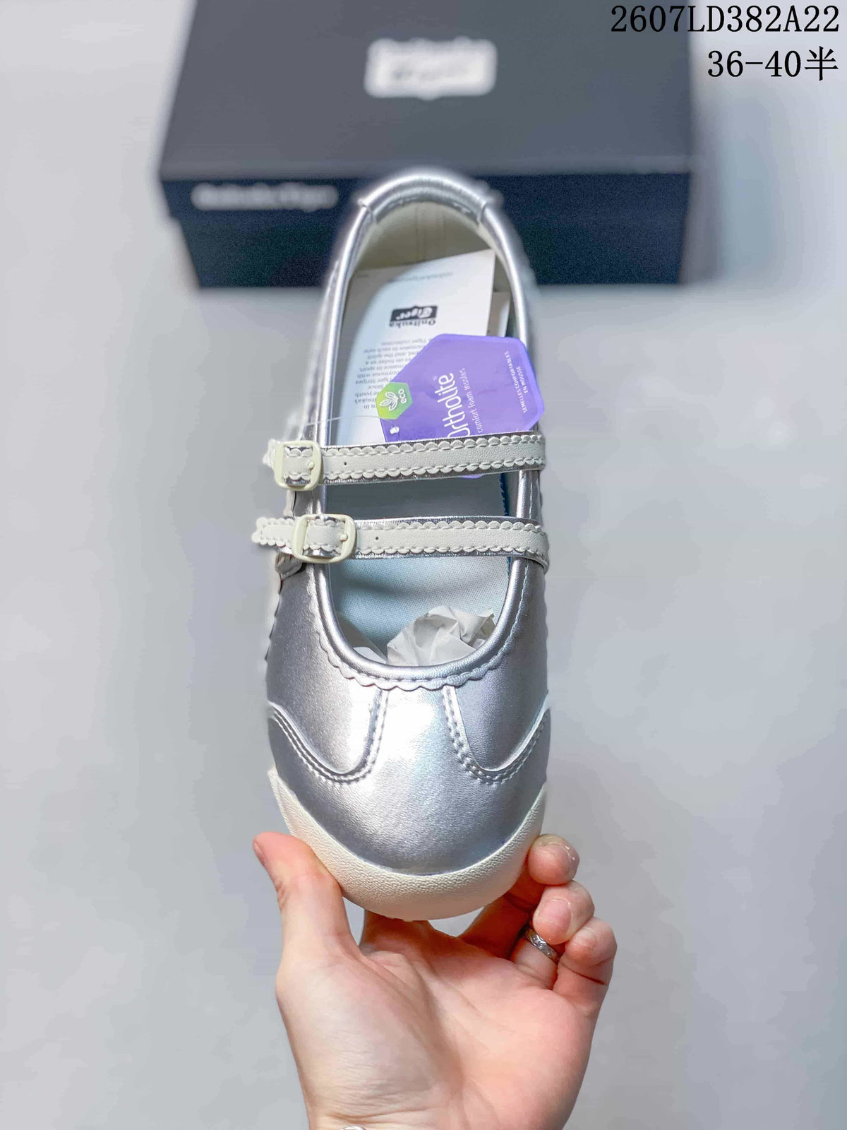 Top view of the sneaker showing the rounded toe, stitched overlays, and two adjustable buckle straps.