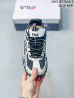 Top view of a black-and-white FILA sneaker showing the lace-up front, padded tongue, and mesh upper; overlay shows style code 2607JWD765A15 and size range 35.5–40.5.