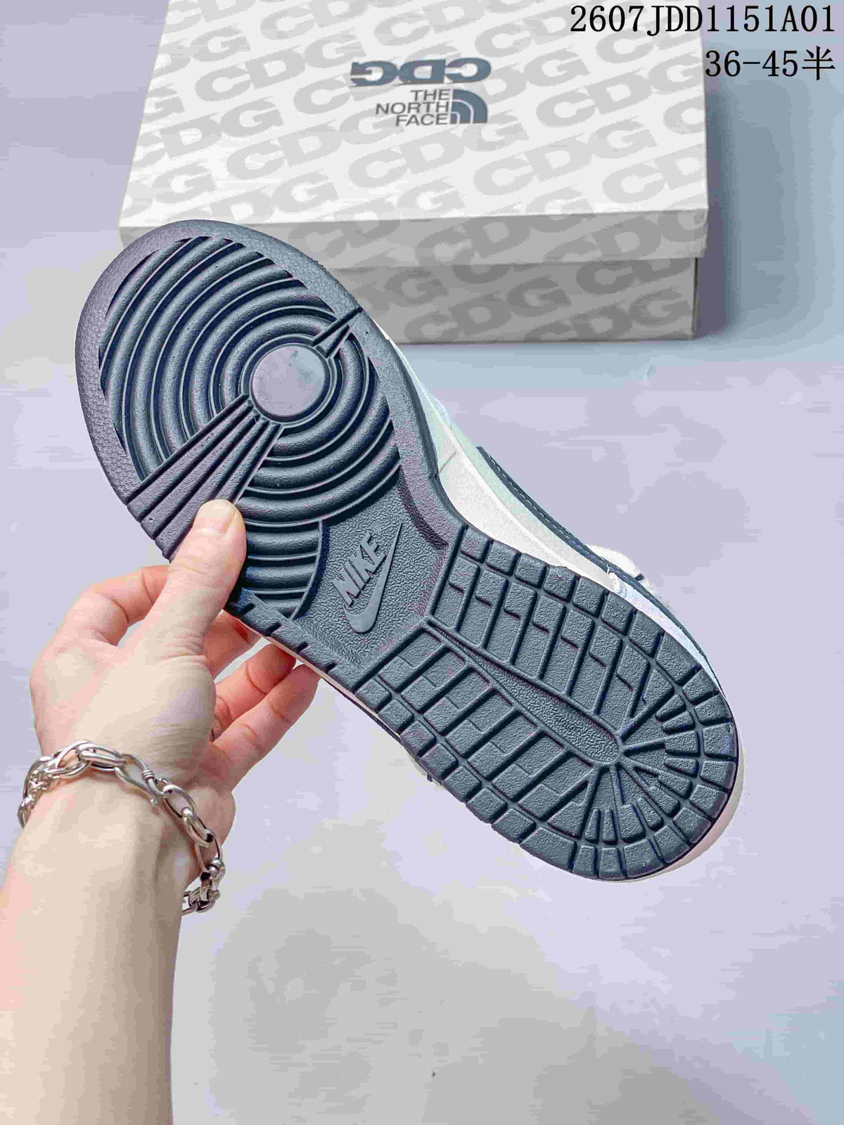 Close-up of the dark patterned outsole and branded shoe box